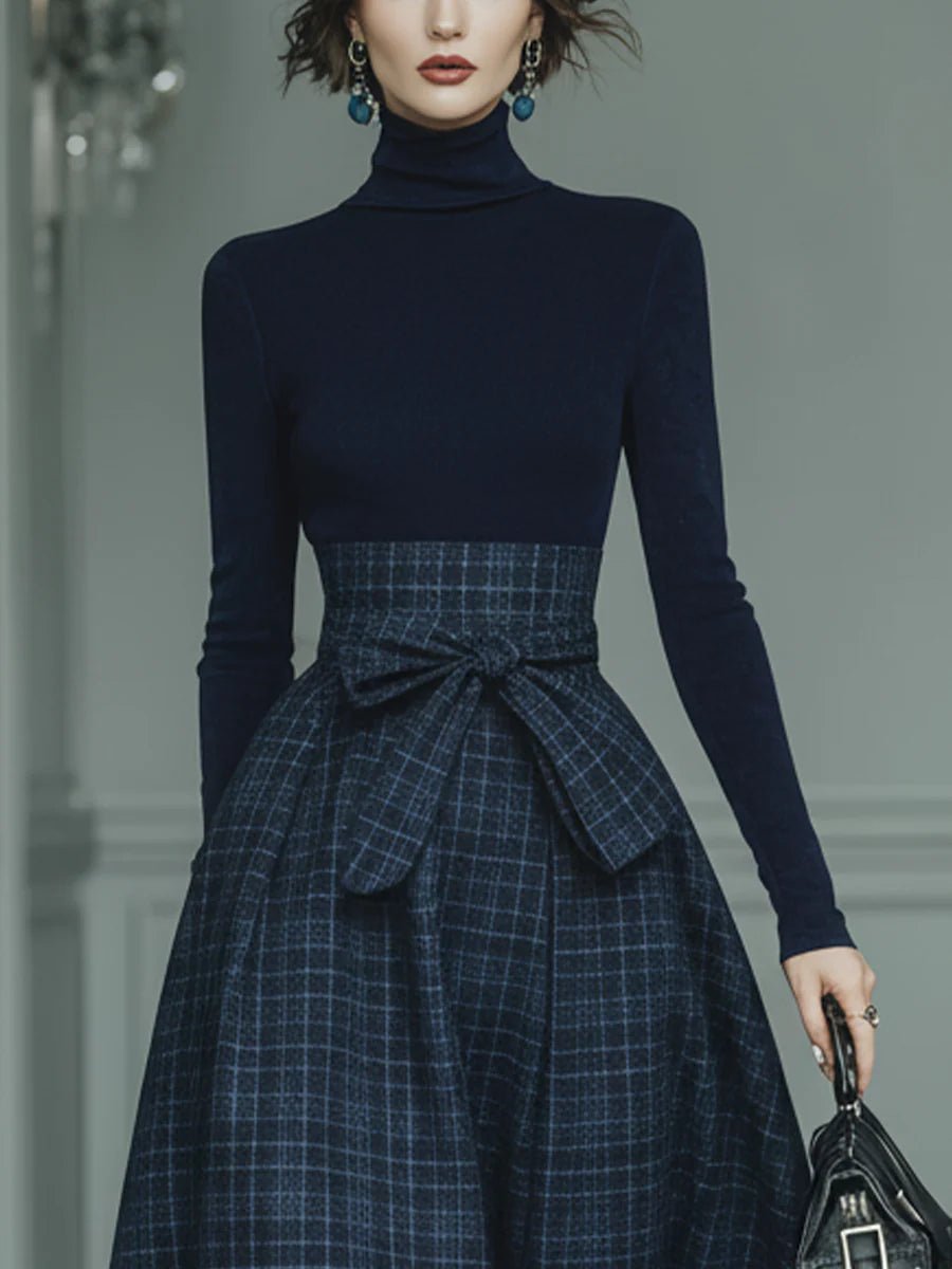 Conjunto de punto azul oscuro con cuello alto y falda de cuadros