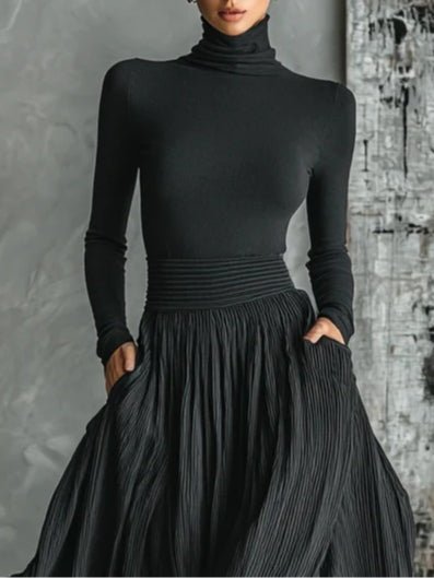 Conjunto negro de top de cuello alto y falda plisada